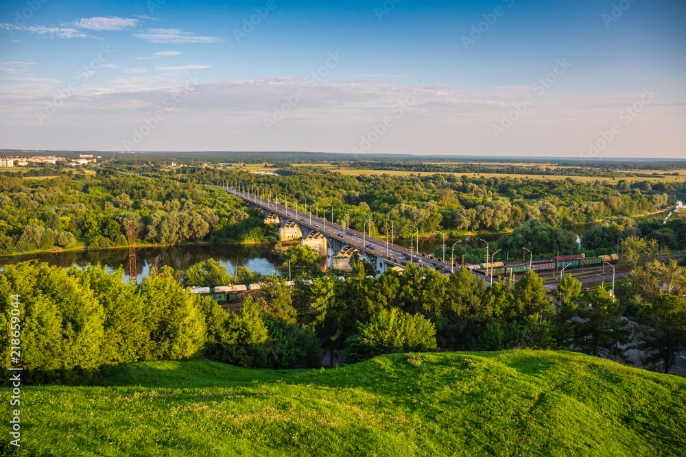 Panoramic view of bridge over river Klyazma in Vladimir city with railroad and green trees