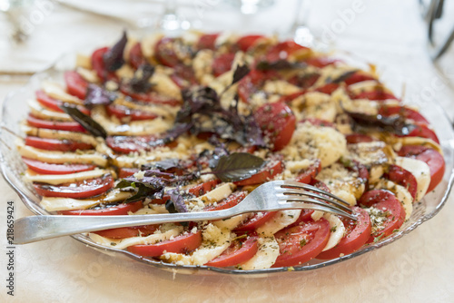 Healthy appetizer - caprese salad with tomato and mozzarella, italian food of mediterranean diet