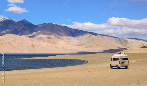 Tourist vehicle at the scenic high altitude Tso Moriri lake Ladakh India 