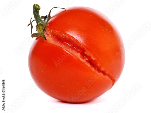 A burst of ripe fresh juicy red tomato on a white background. Isolated photo