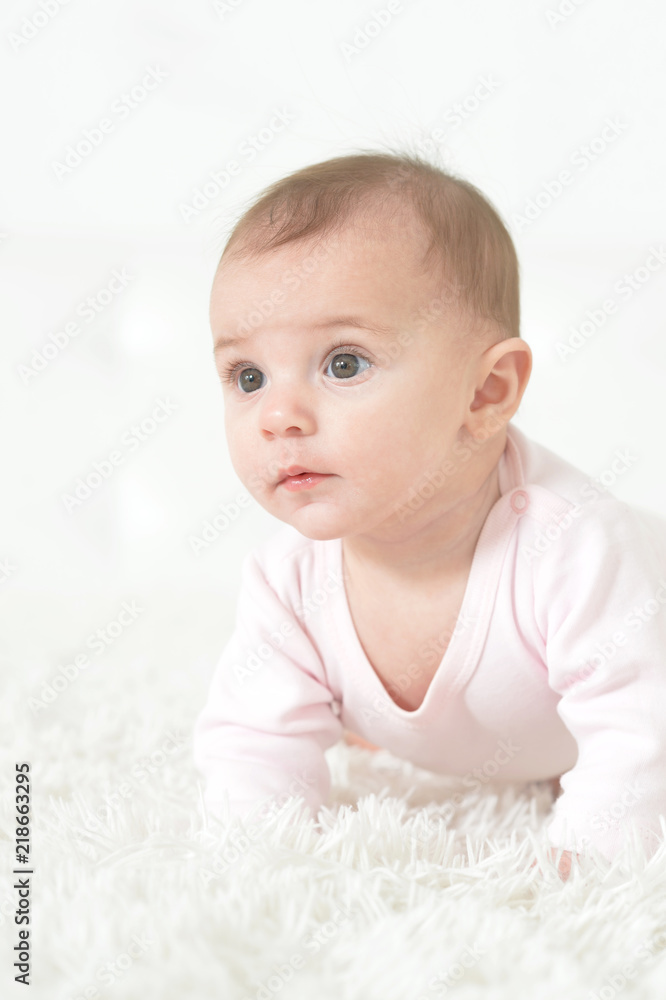 Portrait of a cute baby girl on light background Portrait of a cute baby girl on light background