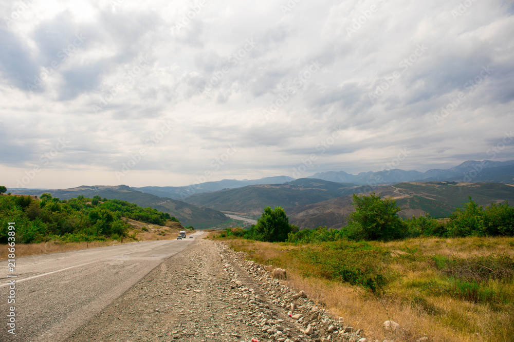 Majestic landscape of the mountains and forest in Caucasus at summer. Dramatic sky with clouds. Majestic landscape of the mountains and forest in Caucasus at summer. Dramatic sky with clouds.