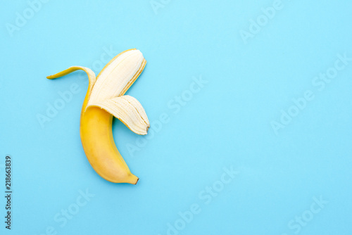 Yellow ripe banana peeled half