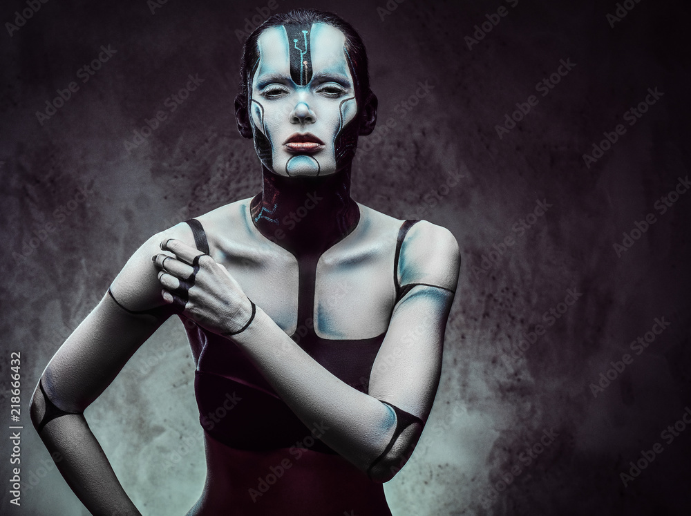 Sensual cyber woman with creative make-up. Technology and future concept. Isolated on a dark textured background. Sensual cyber woman with creative make-up. Technology and future concept. Isolated on a dark textured background.
