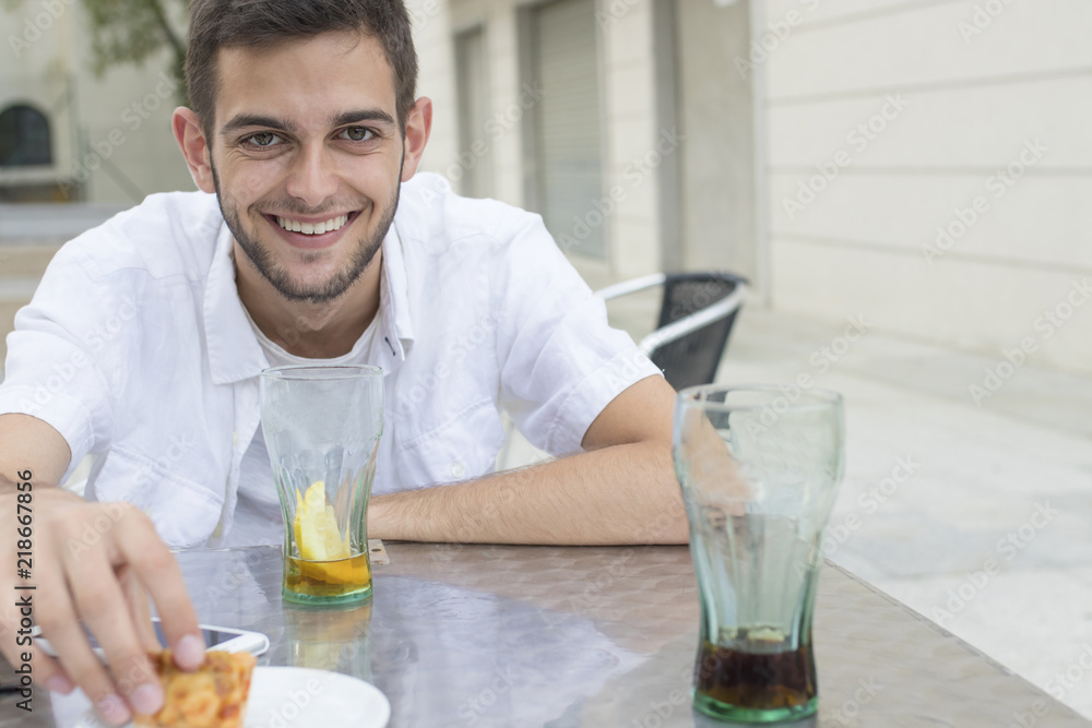 portrait of young adult on the outdoor terrace eating portrait of young adult on the outdoor terrace eating