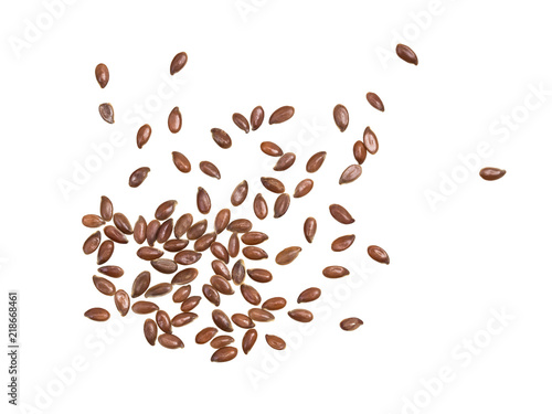 Some linseeds or flax seed spread out and isolated on white background seen from above