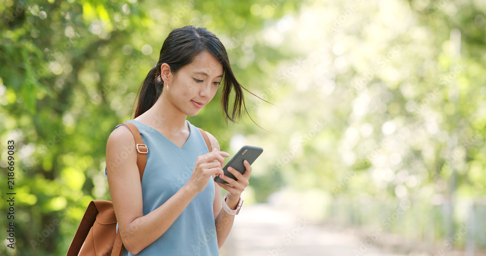 Woman work on mobile phone over green background Woman work on mobile phone over green background
