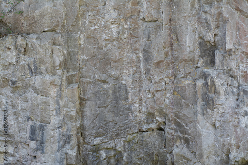 The background of a smooth stone wall of the mountain