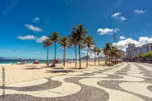 Palms on Copacabana Beach and landmark mosaic sidewalk in Rio de Janeiro, Brazil.