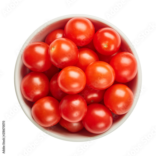 Fresh ripe tomatoes in ceramic bowl isolated on white background. Ingredients for cooking. Top view.