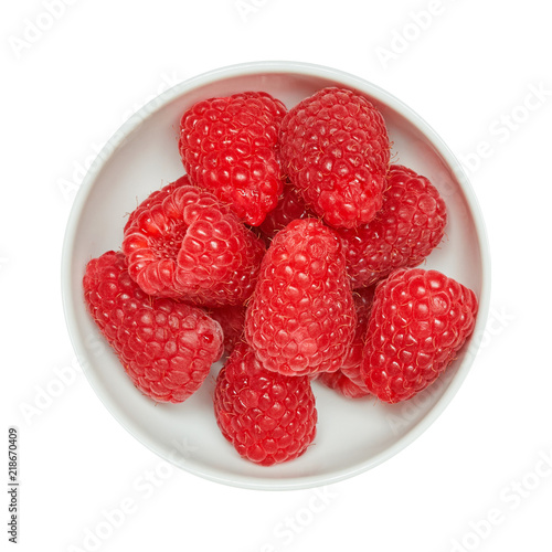 Fresh ripe raspberries in ceramic bowl isolated on white background. Ingredients for cooking. Top view.