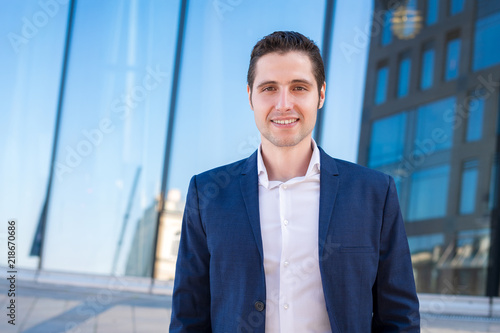 Handsom young businessman portret on blue industrial background