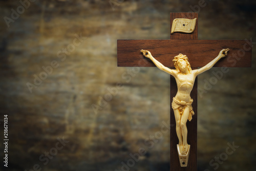Billede på lærred wood crucifix on a grunge wood background with the body of Christ on the cross,