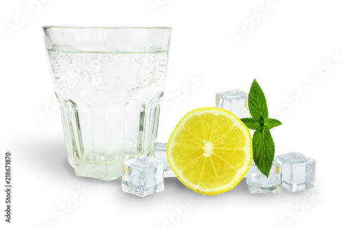 a glass of soda next to ice, mint and lemon, ingredients for lemonade