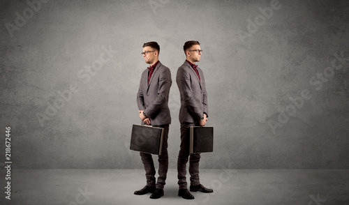 Young conflicted businessman choosing between two directions © ra2 studio