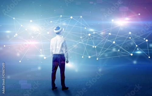 Young businessman standing with vj glasses and checking life-sized connectivity project  