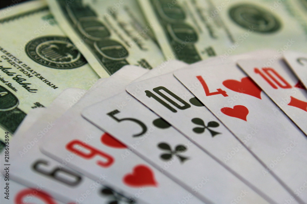 playing cards and money dollars are spread out on the table playing cards and money dollars are spread out on the table