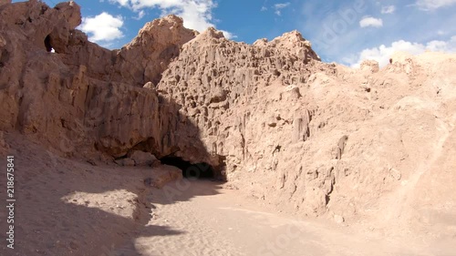 Smooth approach of a cave at Valle De La Luna desert Chile. San Pedro De Atacama. Sunny warm yellow day sandrock formations.