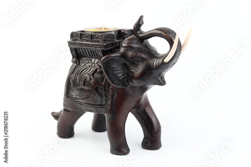 Black elephant made of resin like wood carving with candle holder with white sesame. Stand on white background  Isolated  Art Model Thai Crafts  For decoration Like in the spa.