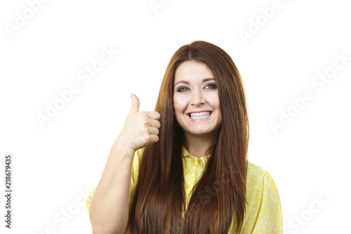 Cheerful woman showing thumb up