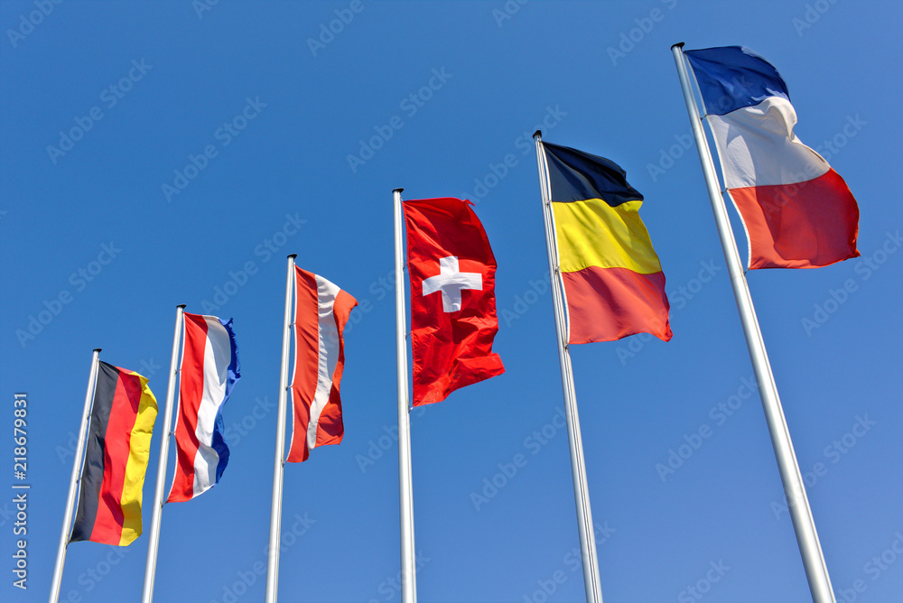 The national flags of Germany, the Netherlands, Austria, Switzerland, Belgium and France flying in front of a blue sky The national flags of Germany, the Netherlands, Austria, Switzerland, Belgium and France flying in front of a blue sky