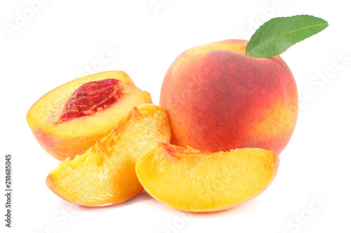 peach fruit with green leaf and slices isolated on white background
