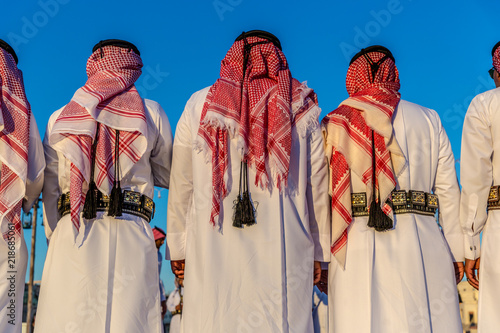 Doha, Qatar, Jan 9th 2018 - Colorful celebration in Doha, with local people dressed with traditional clothes, blue sky day, music instruments and audience in Doha, Qatar. photo