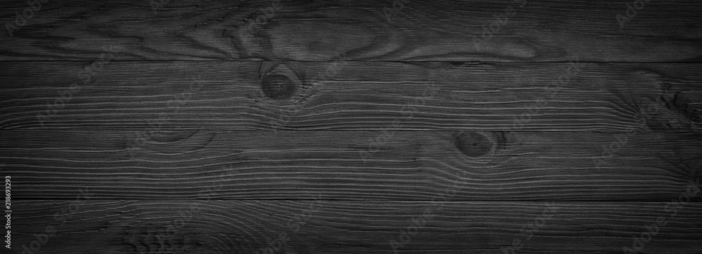 Obraz premium Panorama of black wooden boards, gloomy wood texture, dark background