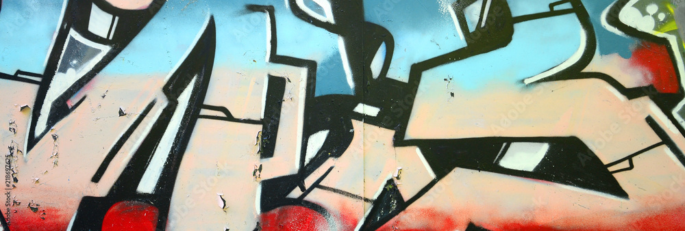 Fototapeta premium Fragment of graffiti drawings. The old wall decorated with paint stains in the style of street art culture. Colored background texture