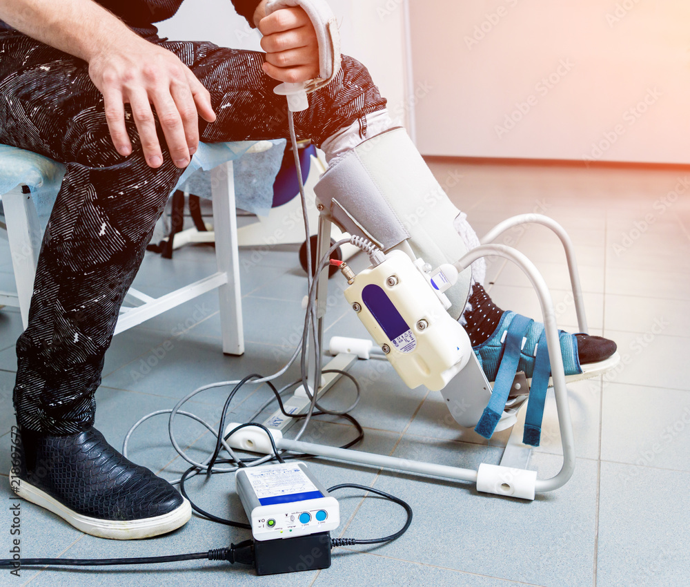 Patient on CPM (continuous passive range of motion) machines. Device to