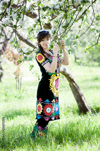 Girl, woman in national historic Tajik costume. Central Asia photo