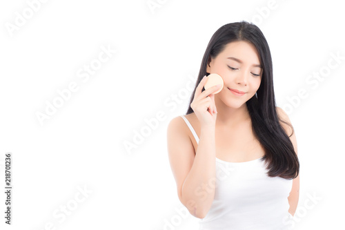 Portrait of beautiful asian woman applying powder puff at cheek makeup of cosmetic, beauty of girl with face smile isolated on white background, wellness and healthcare concept.