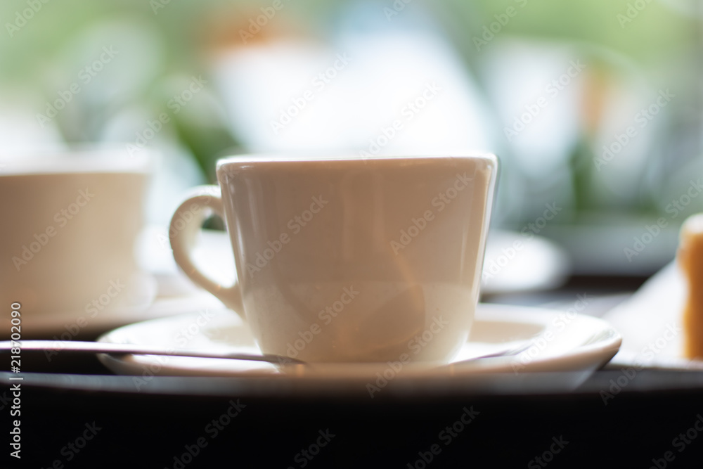 Espresso Macchiato at an italian breakfast bar in a cup on a saucer with a spoon. Espresso Macchiato at an italian breakfast bar in a cup on a saucer with a spoon.