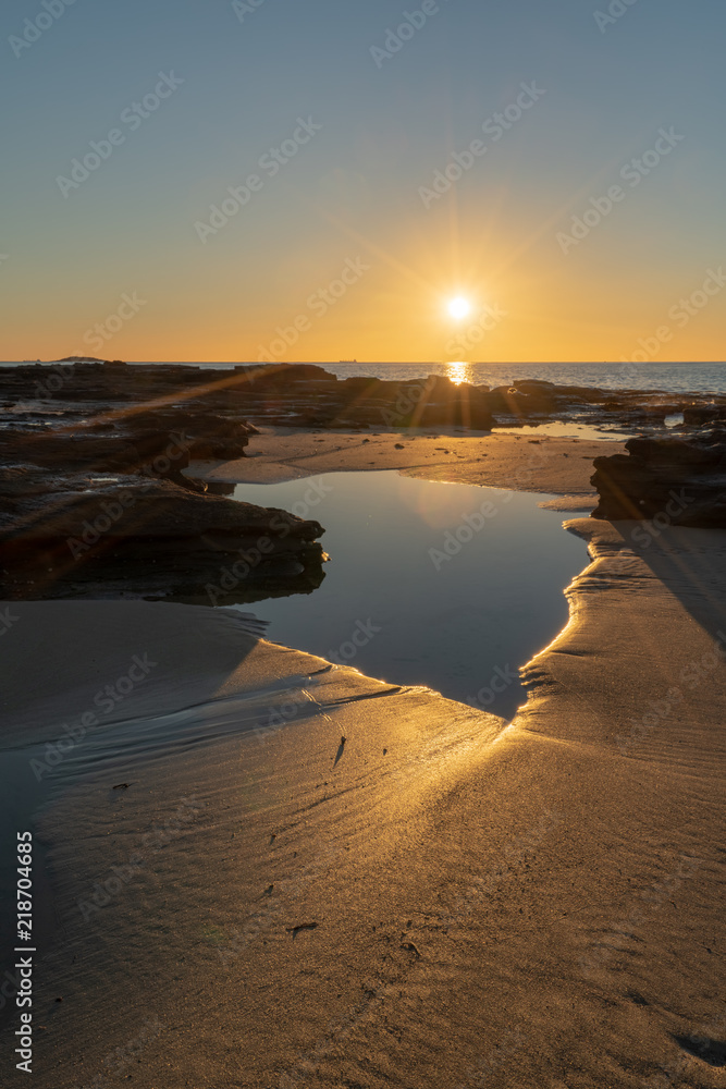 Sunrise over a rocky beach, MM Beach, NSW, Australia