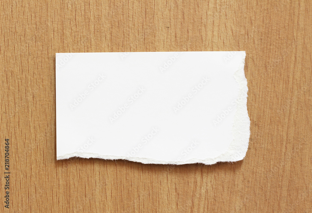 white torn paper texture on wood background, copy space. white torn paper texture on wood background, copy space.