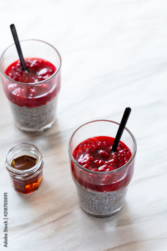Chia pudding with red berry puree and maple syrup