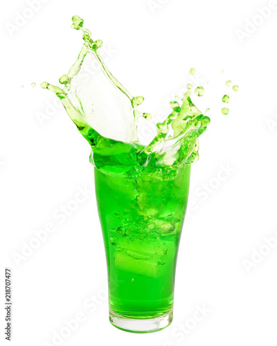 Green soda pop splashing out of glass isolated on white background.
