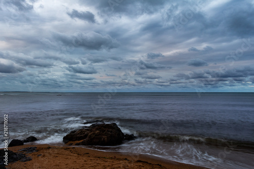 Landscape on the edge of the sea with the cloudy sky