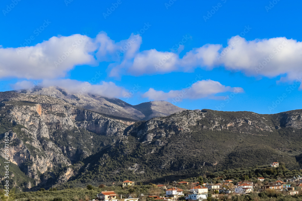 Cloud covered Taygetos mountains of the Peloponnese peninula of Southern Greece looking over the tile roofs of a village on a winters day