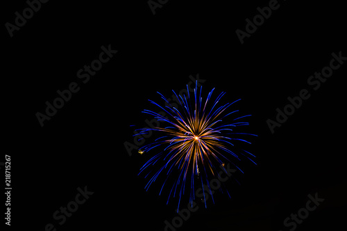 Blue fireworks exploding at night