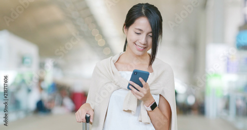 Canvas Print Woman checking on cellphone in the airport