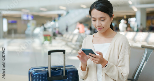 Photography Woman use of mobile phone in the airport