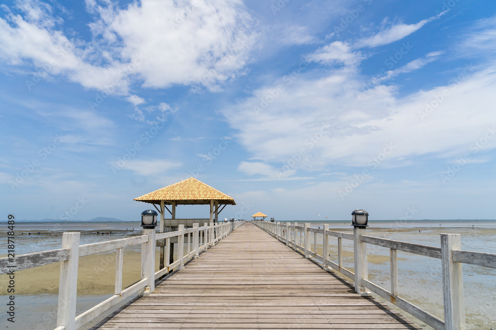 blue sky clear with perspective wooden bridge extending into the sea