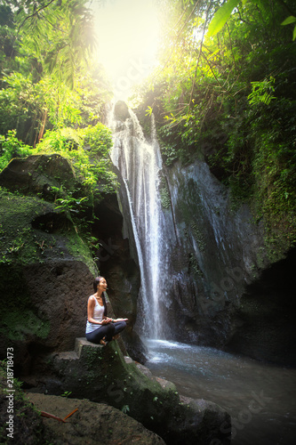 Serenity and yoga practicing at waterfall