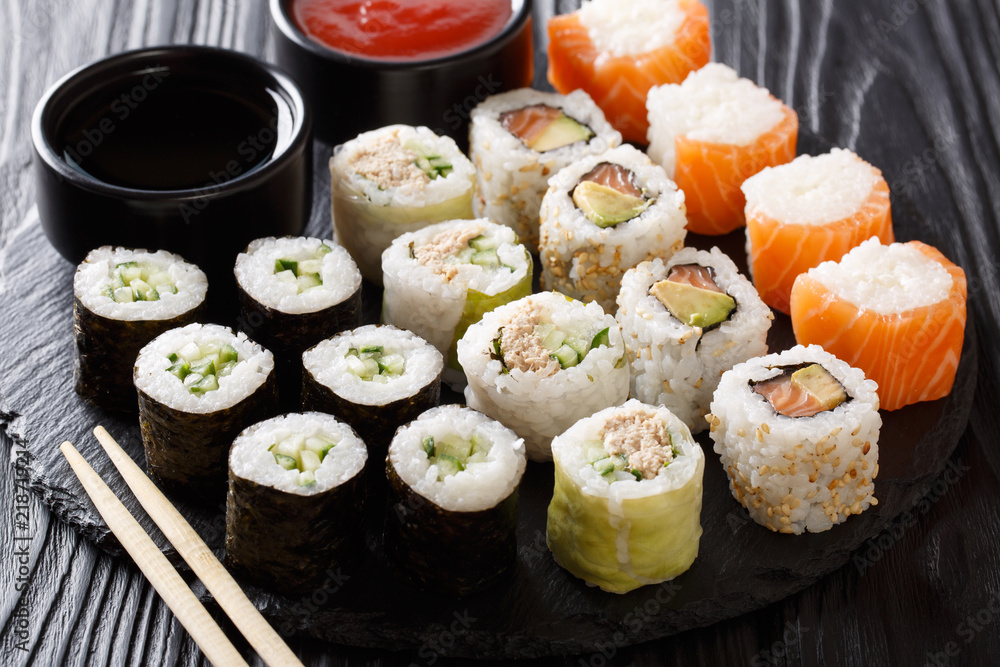 Japanese food: a menu of rolls with seafood close-up with sauces. horizontal Japanese food: a menu of rolls with seafood close-up with sauces. horizontal