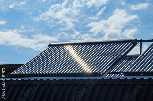 Vacuum solar water heating system on the house roof.