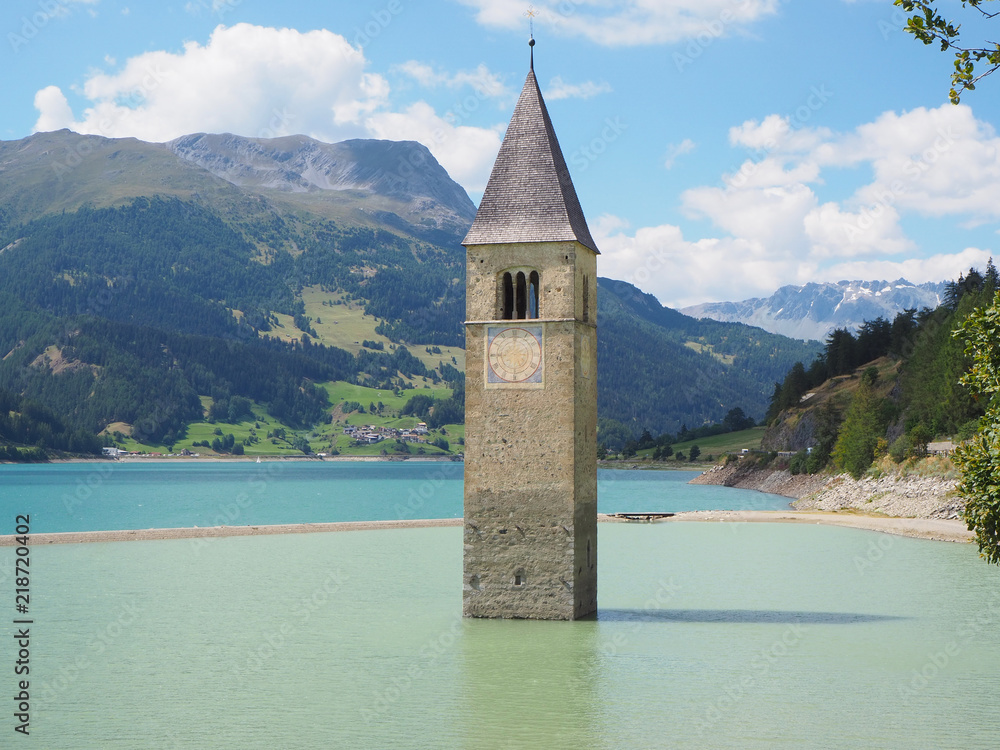 Curon, Italy. View of the old bell tower of the village rising out of the waters lake of Resia