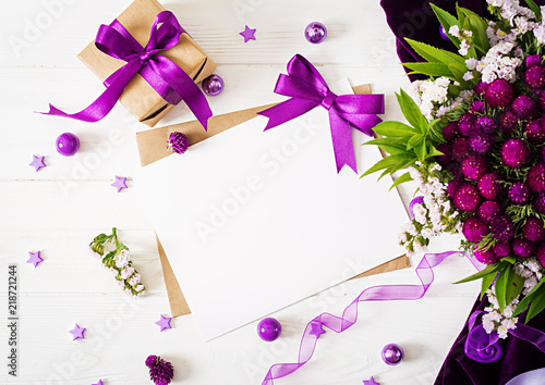 Mockup. Cards and flowers, box gift,violet ribbon and cloth lying on a white table. Flat lay. Top view. Valentines day.