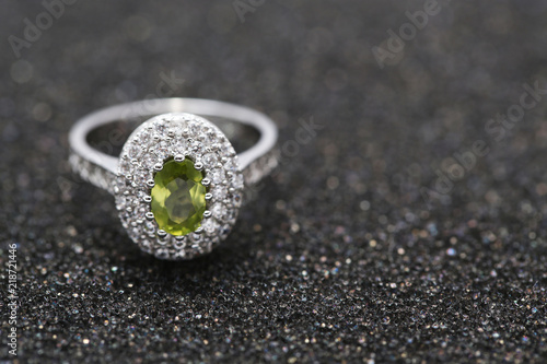 green gem stone on diamond ring