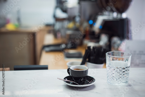 coffee mug and a glass of water on a table